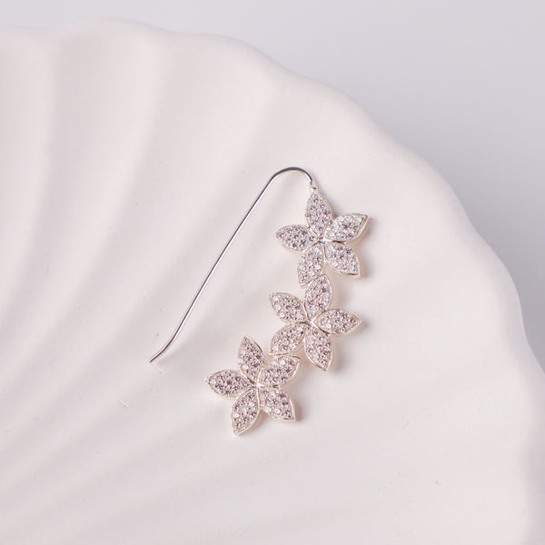 Close-up of CZ flower Nath earring on white background
