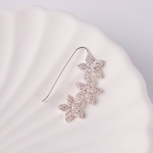 Close-up of CZ flower Nath earring on white background