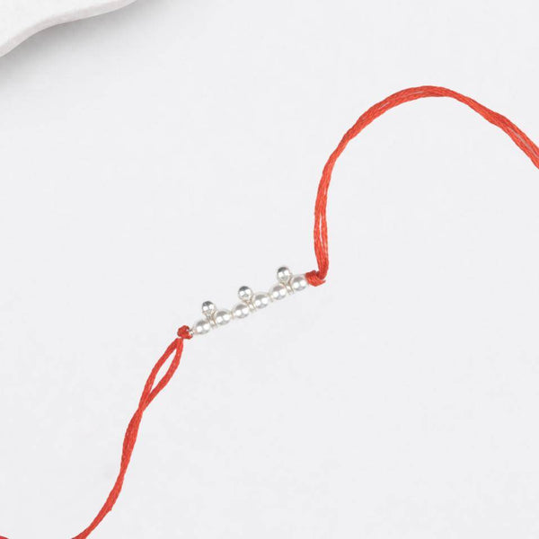 Close-up of Pearl & Silver Bead Rakhi craftsmanship
