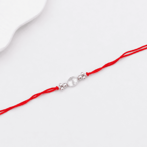 Traditional handcrafted silver Rakhi with baroque pearl detailing