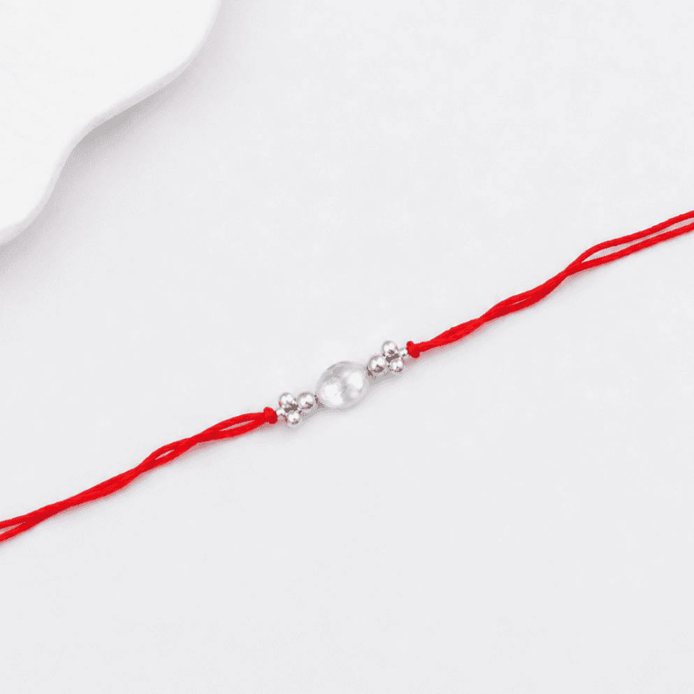 Traditional handcrafted silver Rakhi with baroque pearl detailing