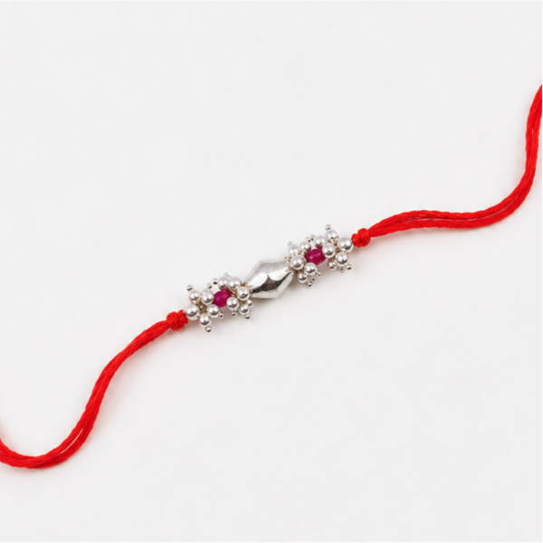 Close-up of Silver Dholki Bead Ruby & Pearl Bunch Rakhi craftsmanship