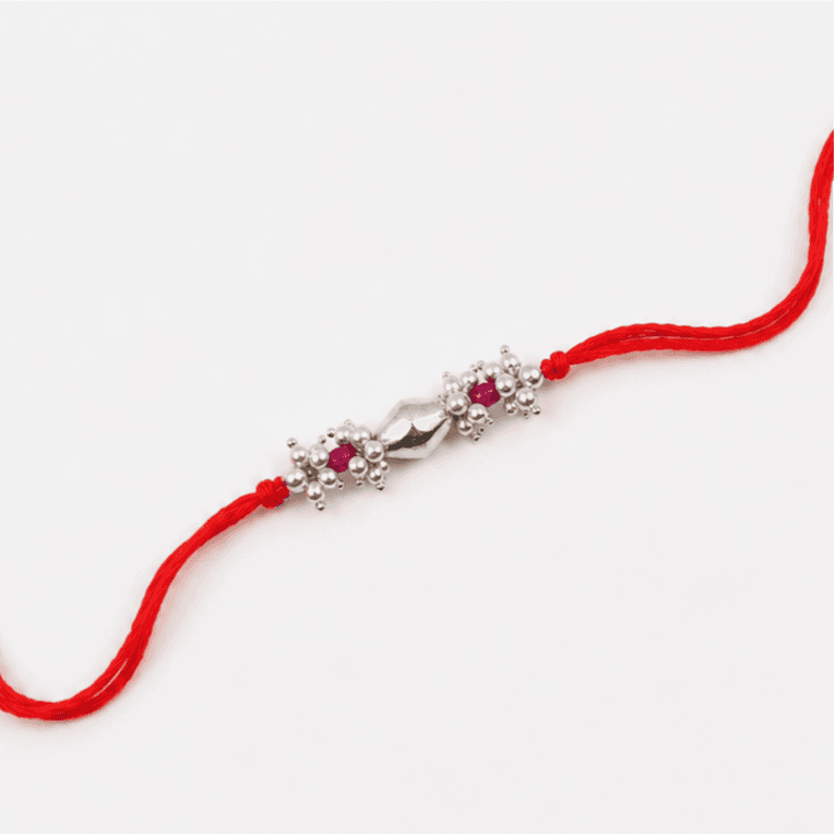 Close-up of Silver Dholki Bead Ruby & Pearl Bunch Rakhi craftsmanship