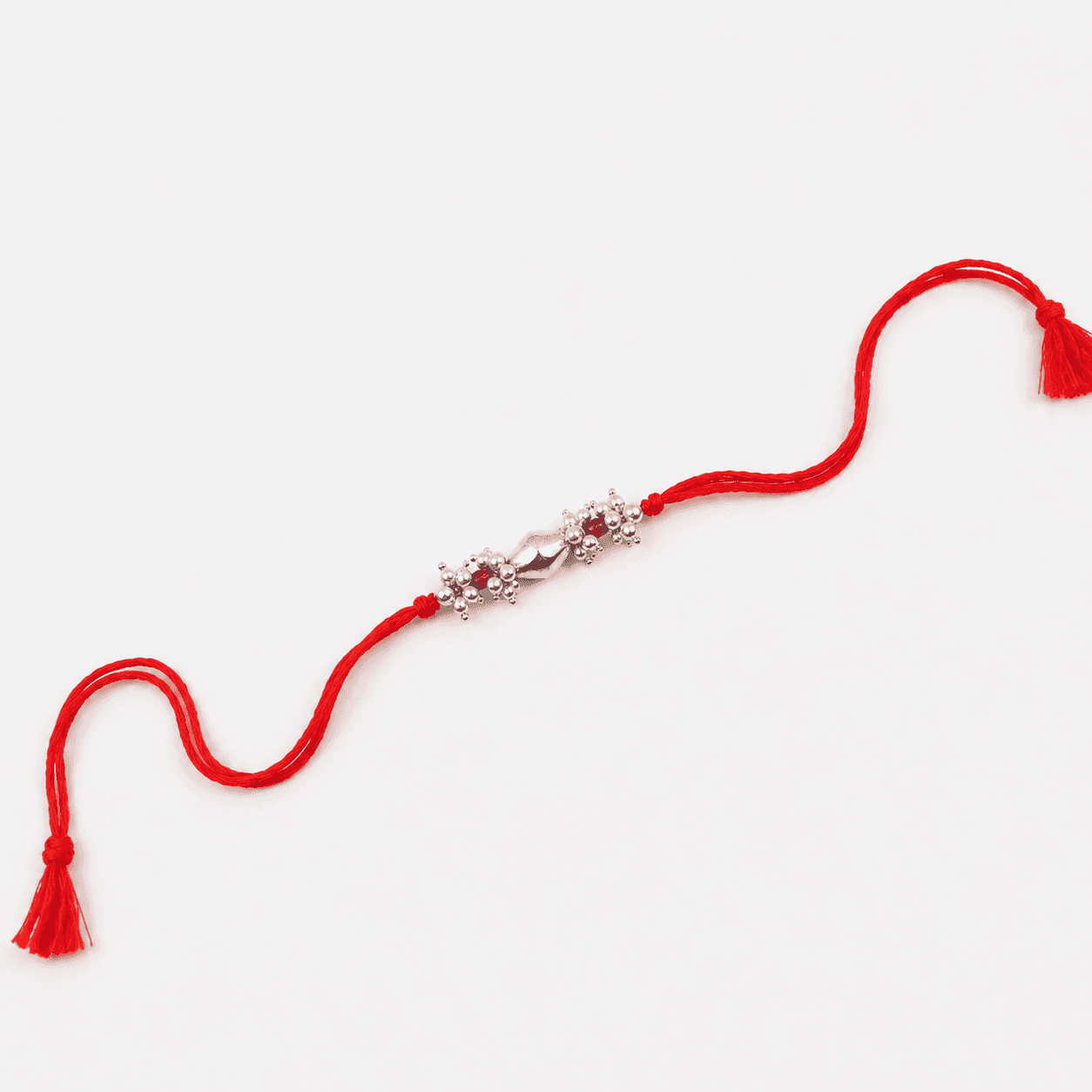 Ruby and pearl gemstone Rakhi with traditional silver Dholki beads