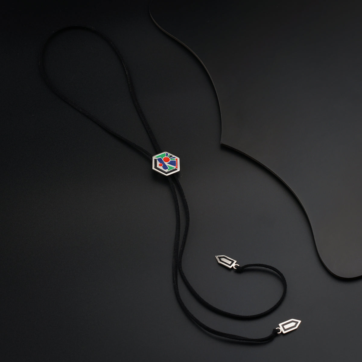 a black cord with a diamond pendant on it