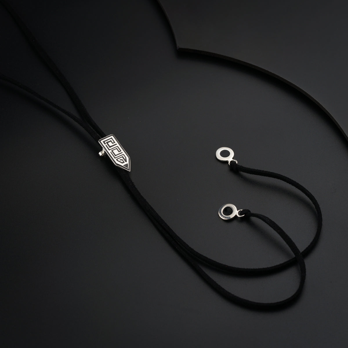 a black cord with a silver clasp on it