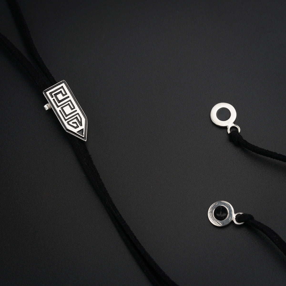 a black cord with a silver logo on it