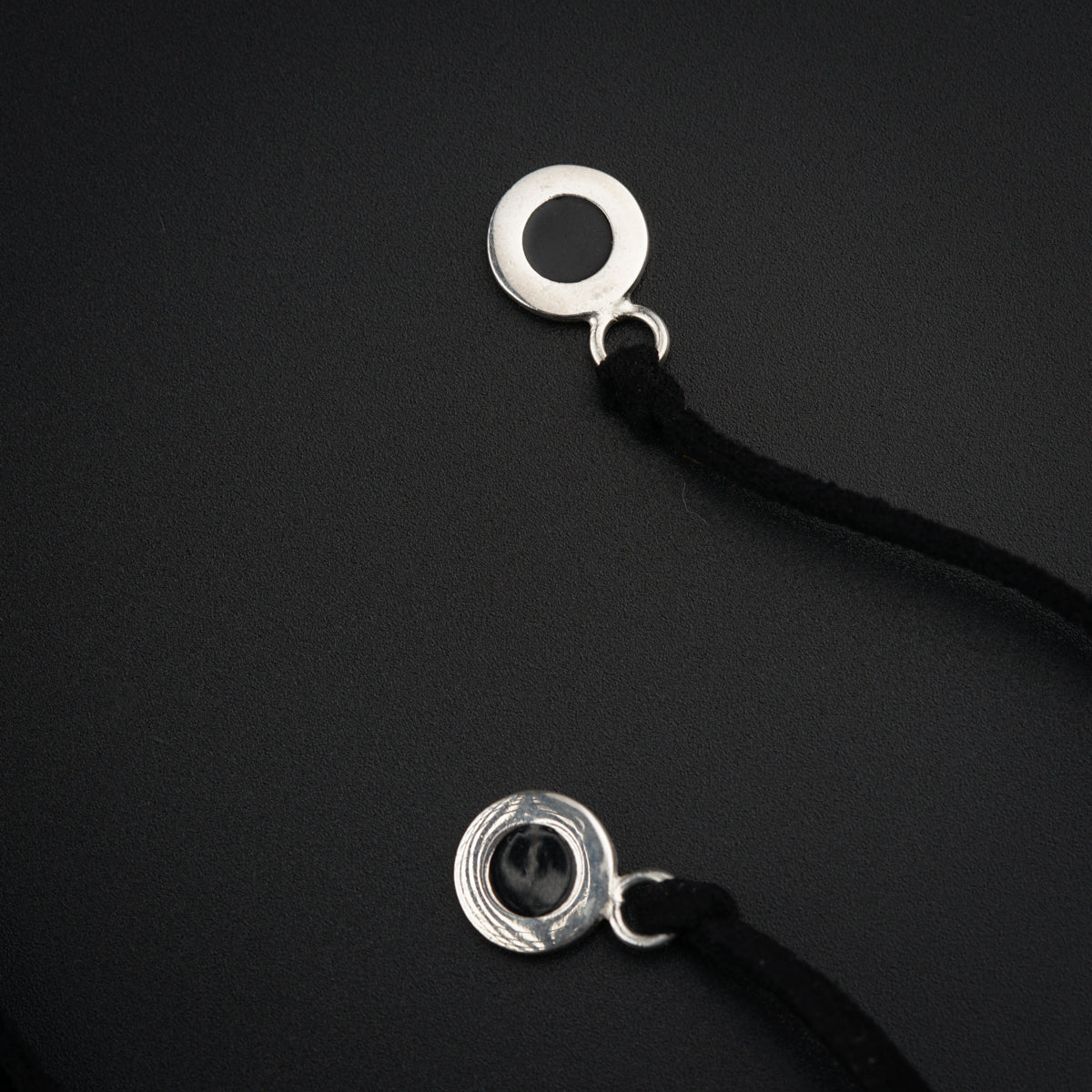 a close up of a metal object on a black surface