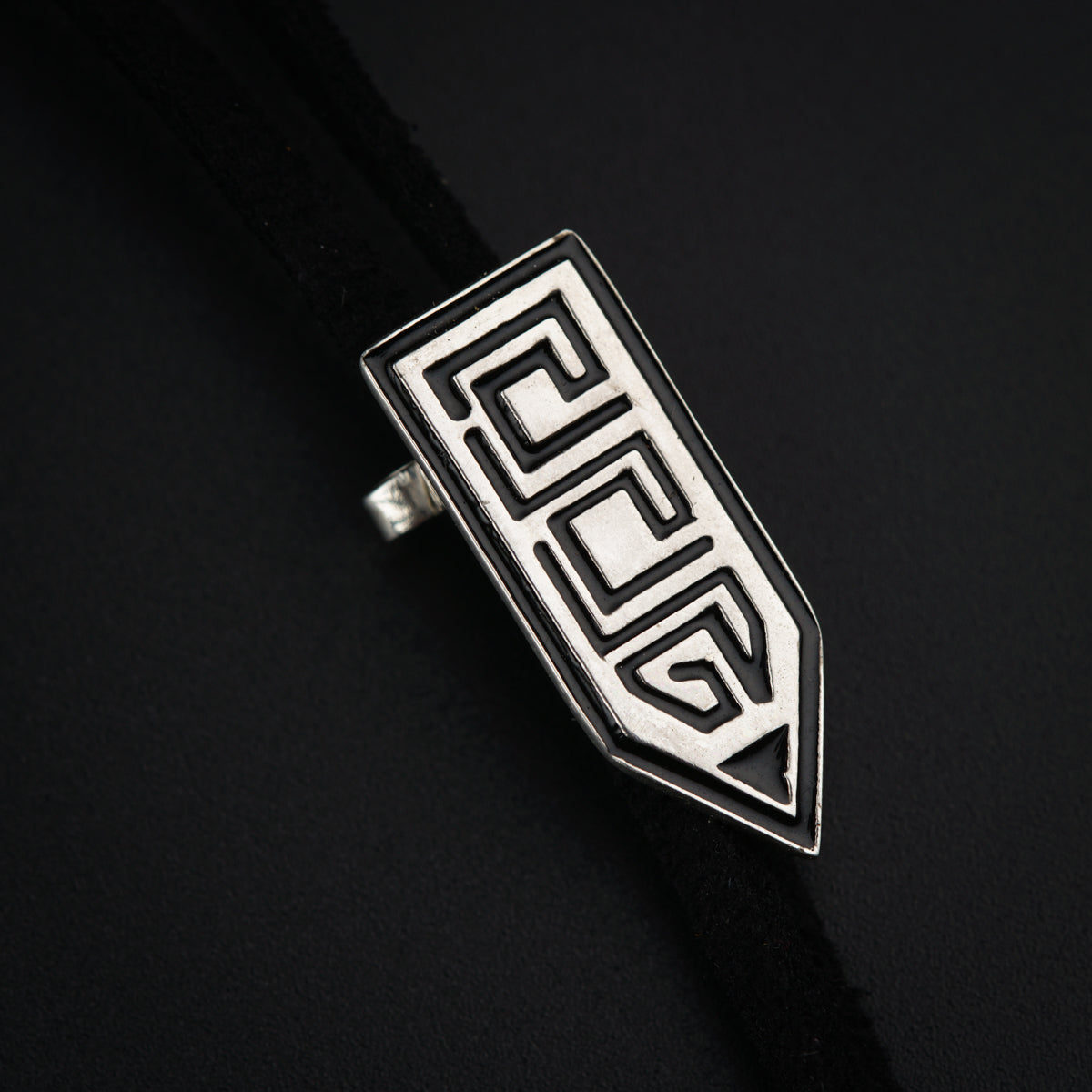 a close up of a metal object on a black surface