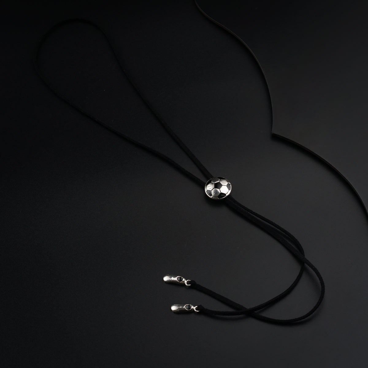 a black cord with two silver beads on it