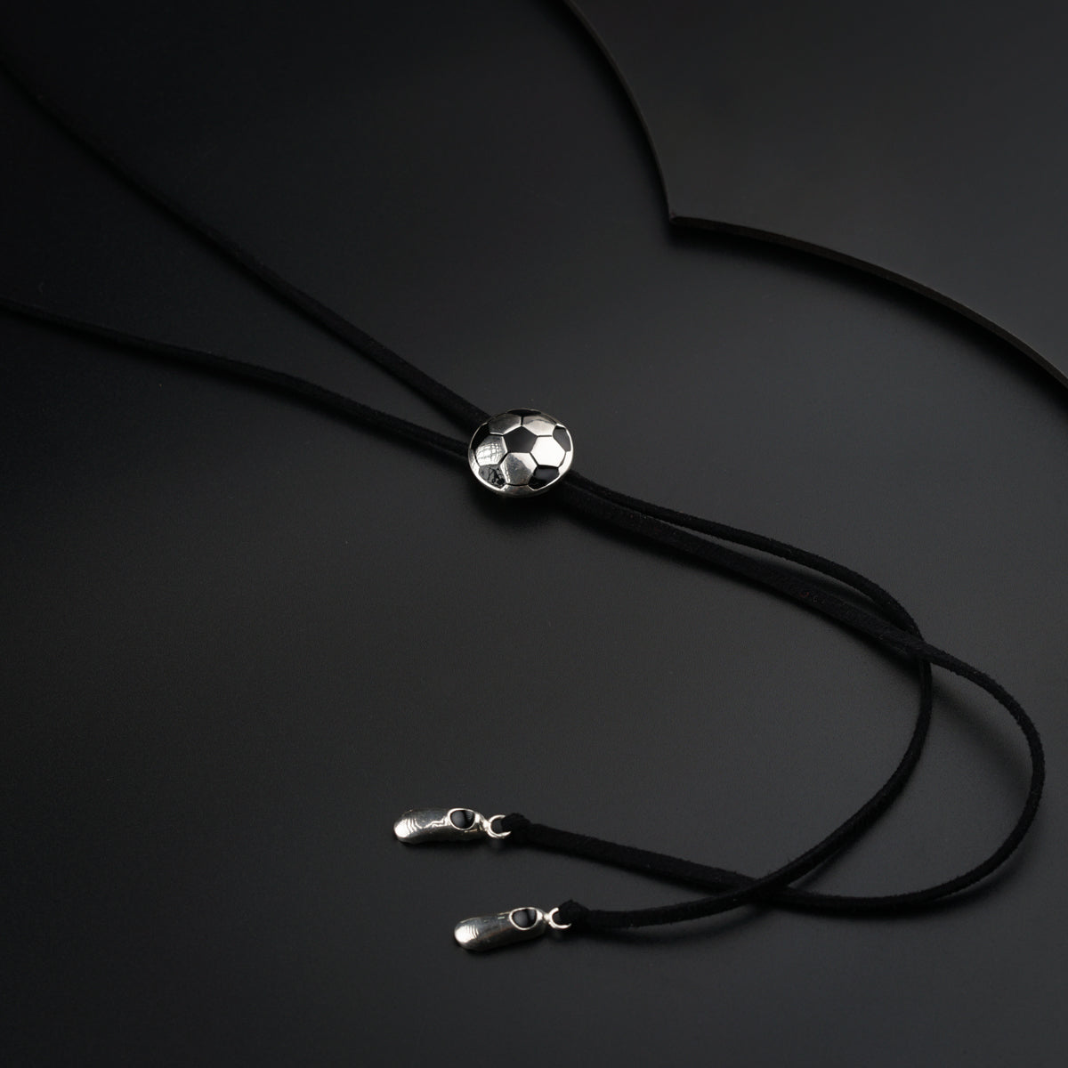 a close up of a necklace on a black surface