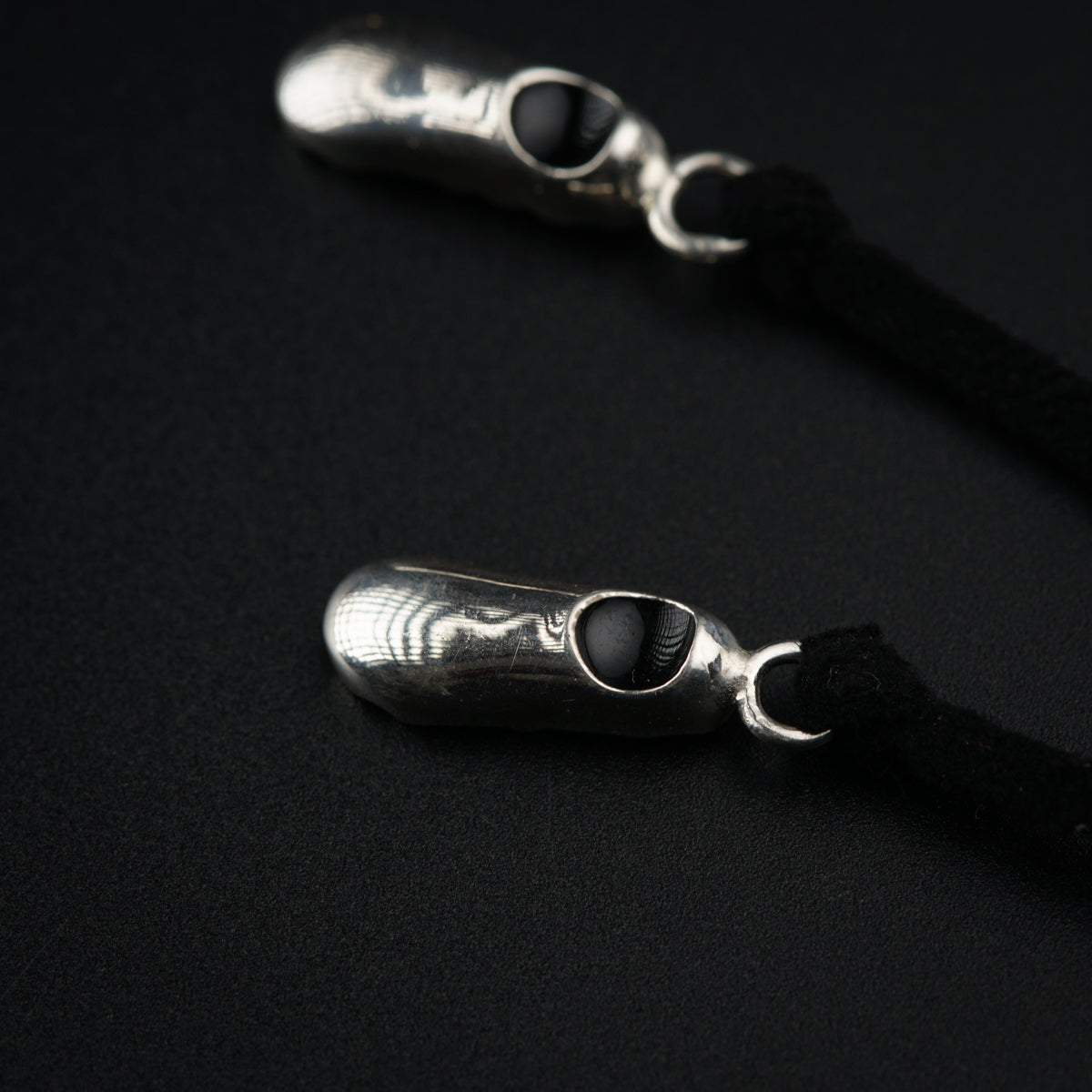 a pair of silver scissors on a black background