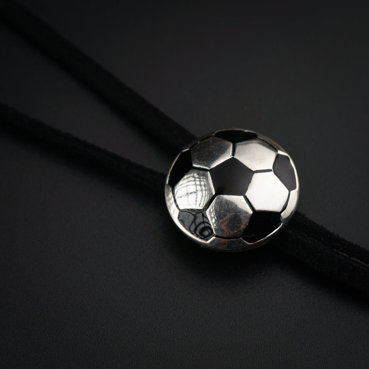 a silver soccer ball on a black background