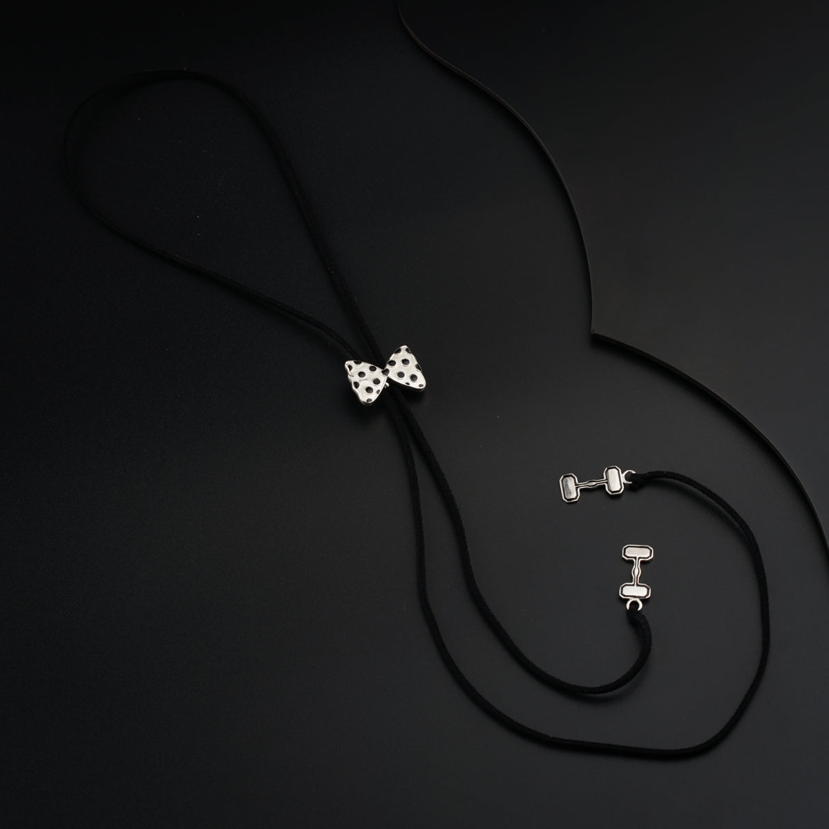 a black cord with a white bow tie on it