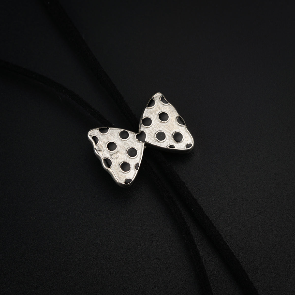a pair of black and white polka dot earrings
