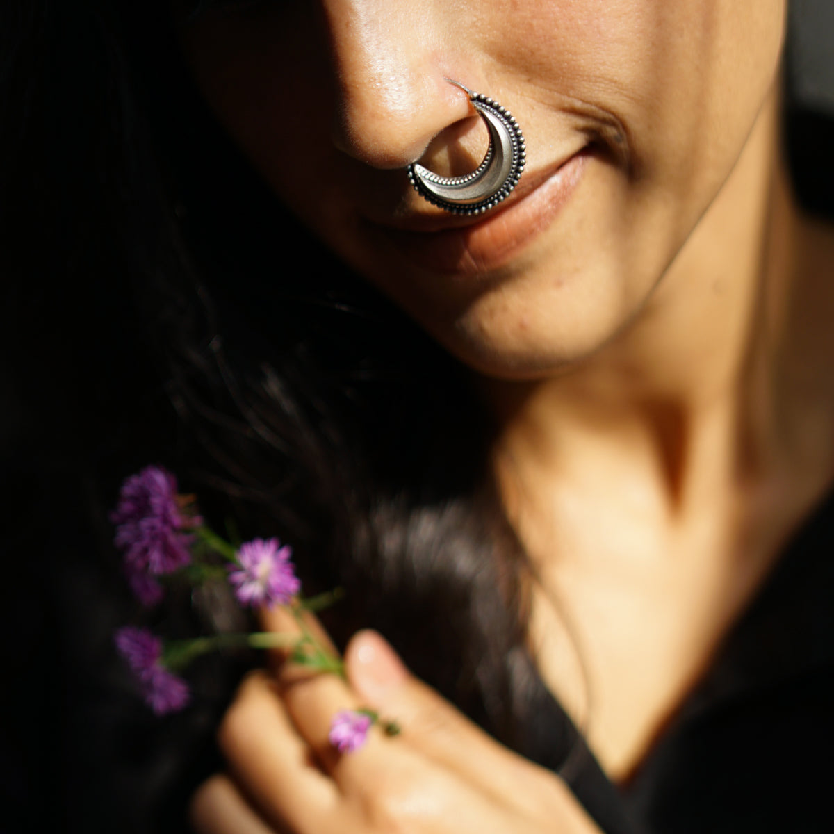 a close up of a person holding a flower