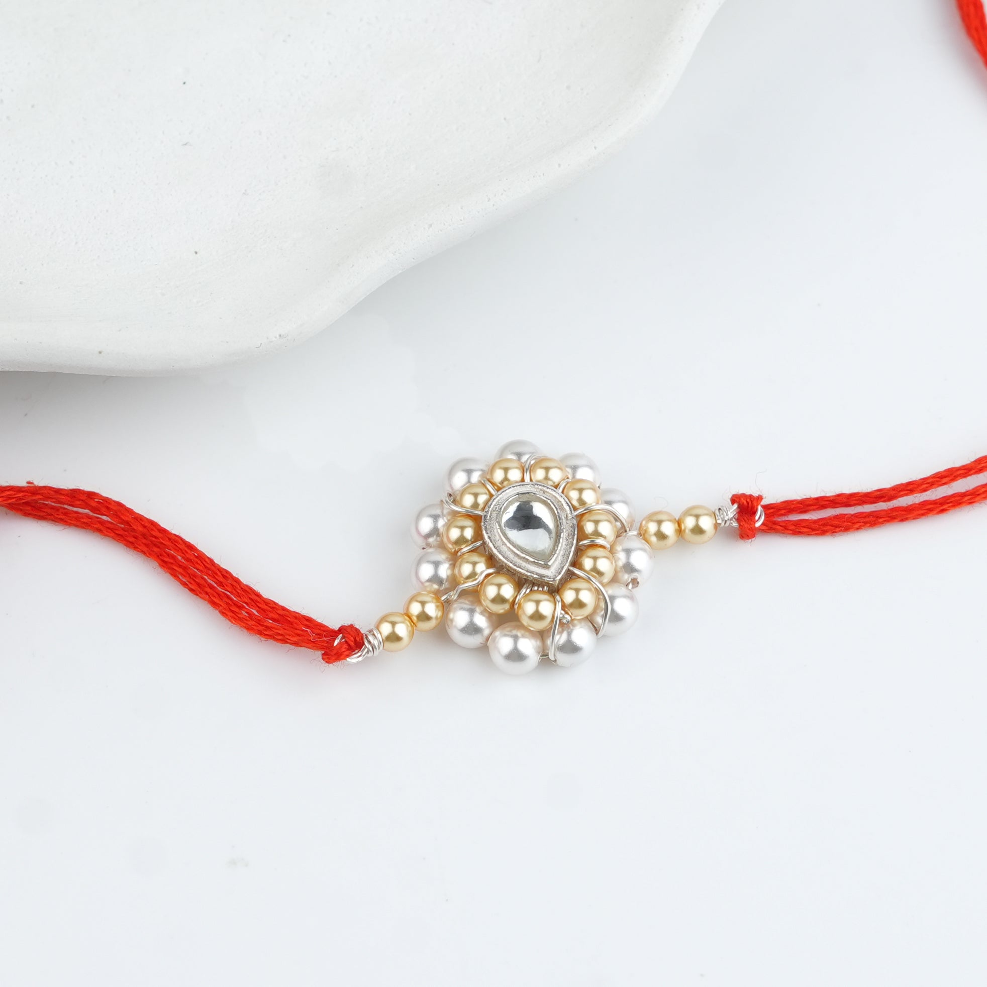 CZ Drop, Golden & White Pearl Handmade Silver Rakhi