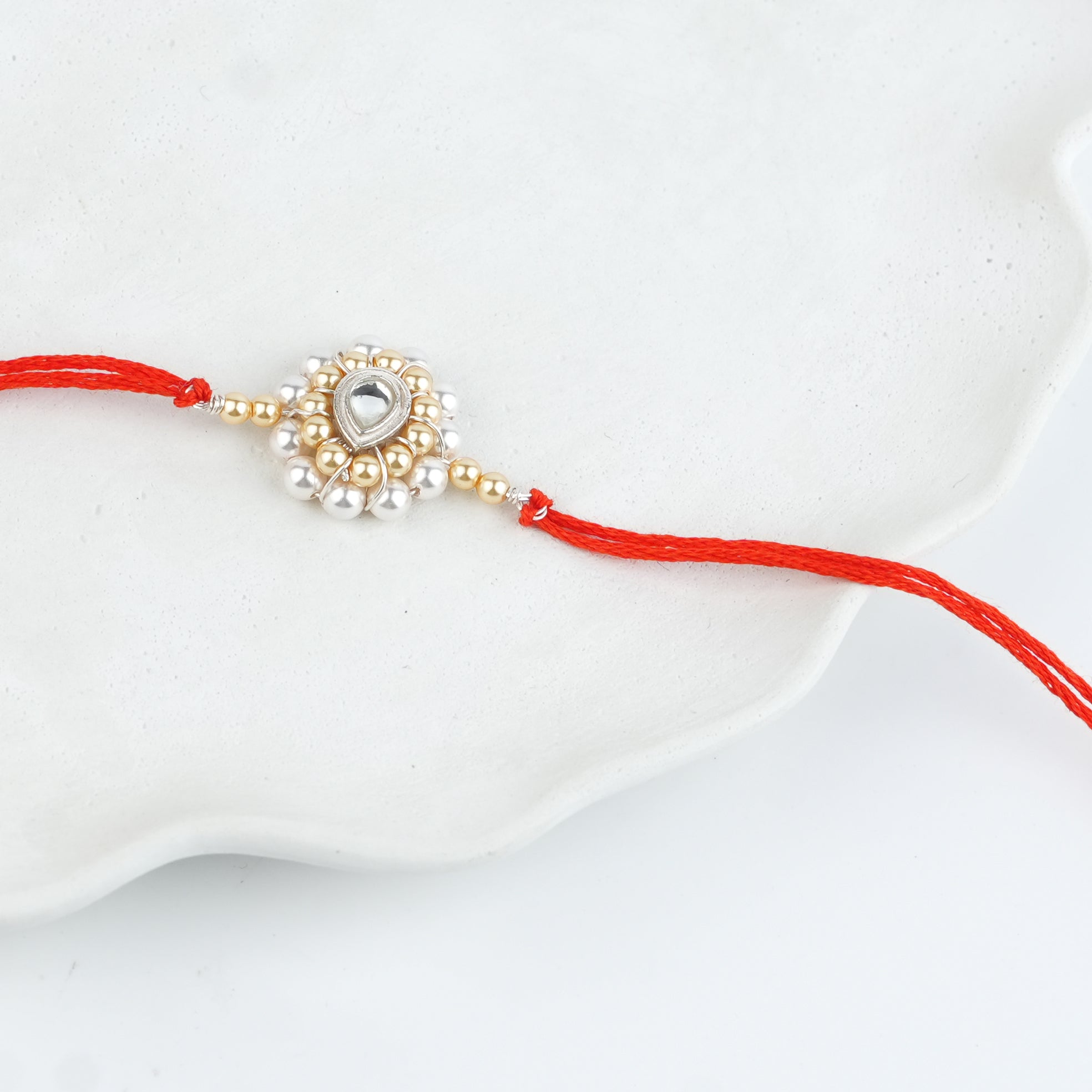 CZ Drop, Golden & White Pearl Handmade Silver Rakhi