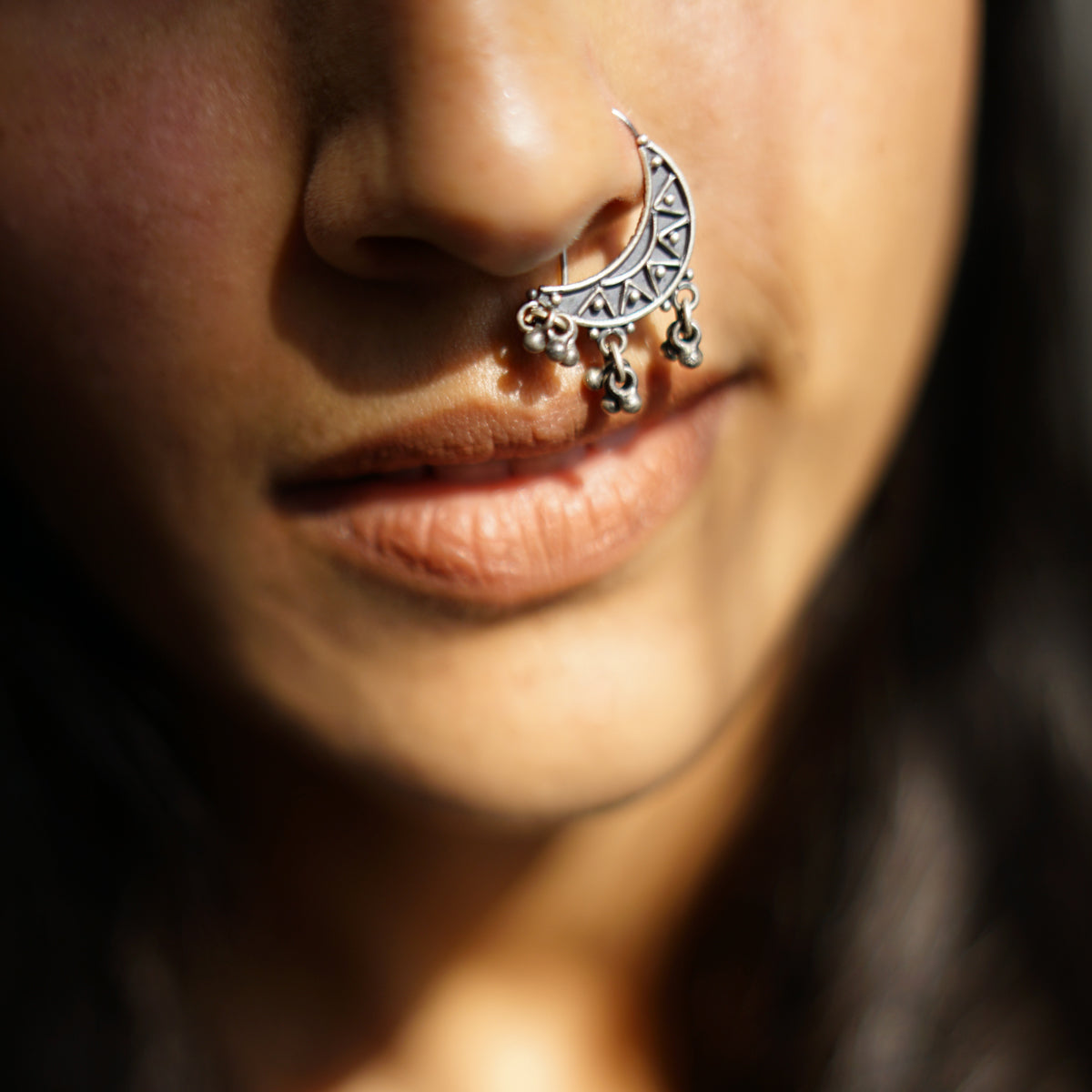 a close up of a person with a nose piercing