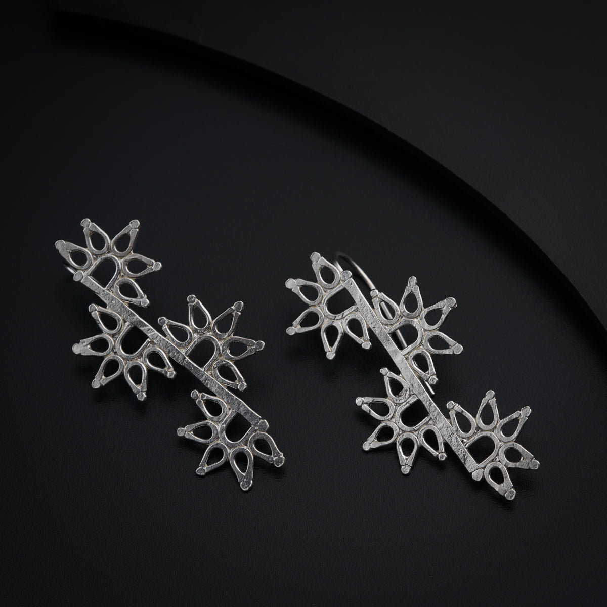 a pair of snowflakes sitting on top of a black surface
