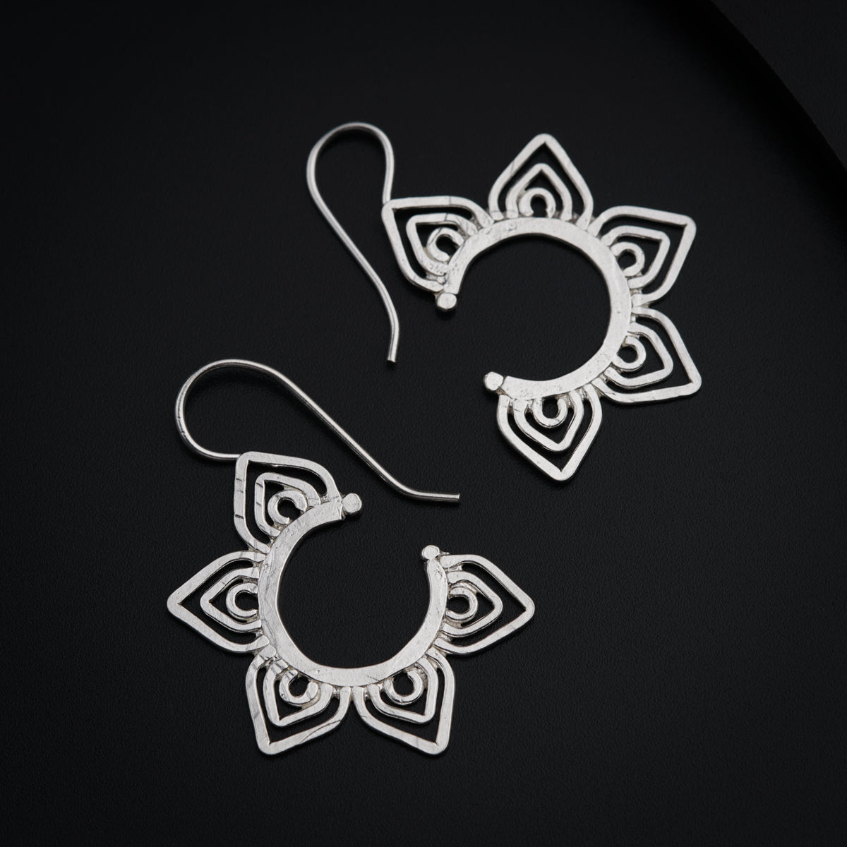 a pair of earrings sitting on top of a table