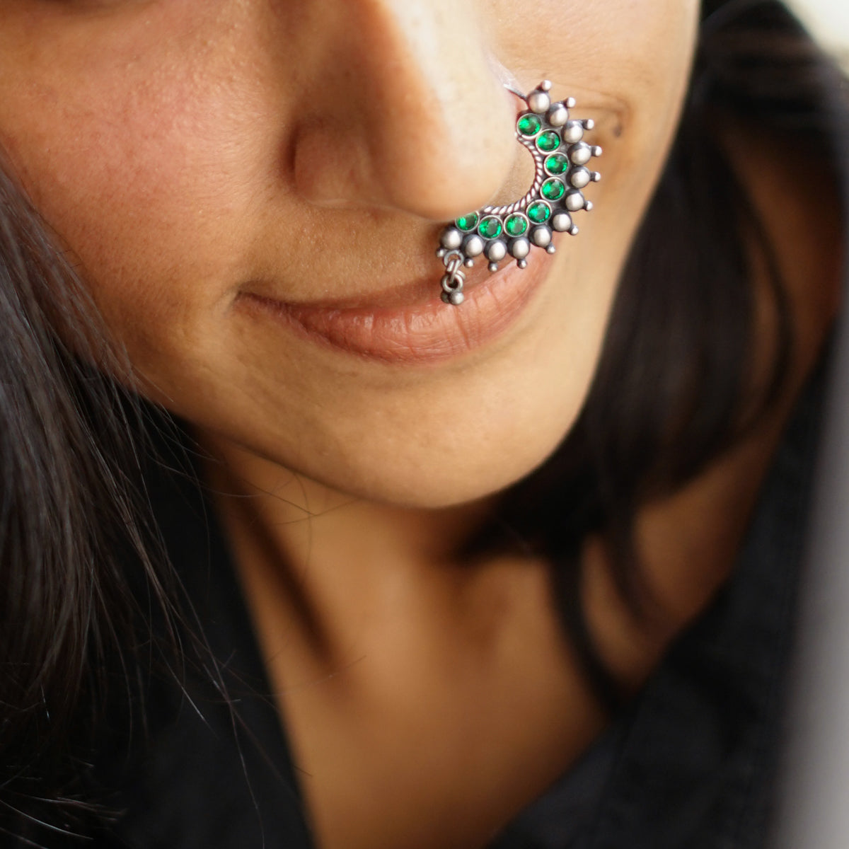 a close up of a person with a nose piercing