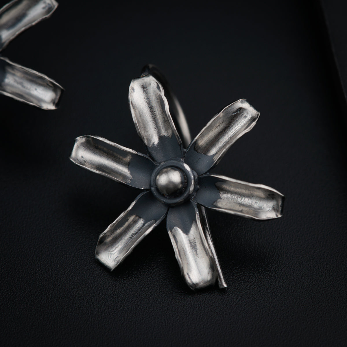 a close up of a metal object on a black surface
