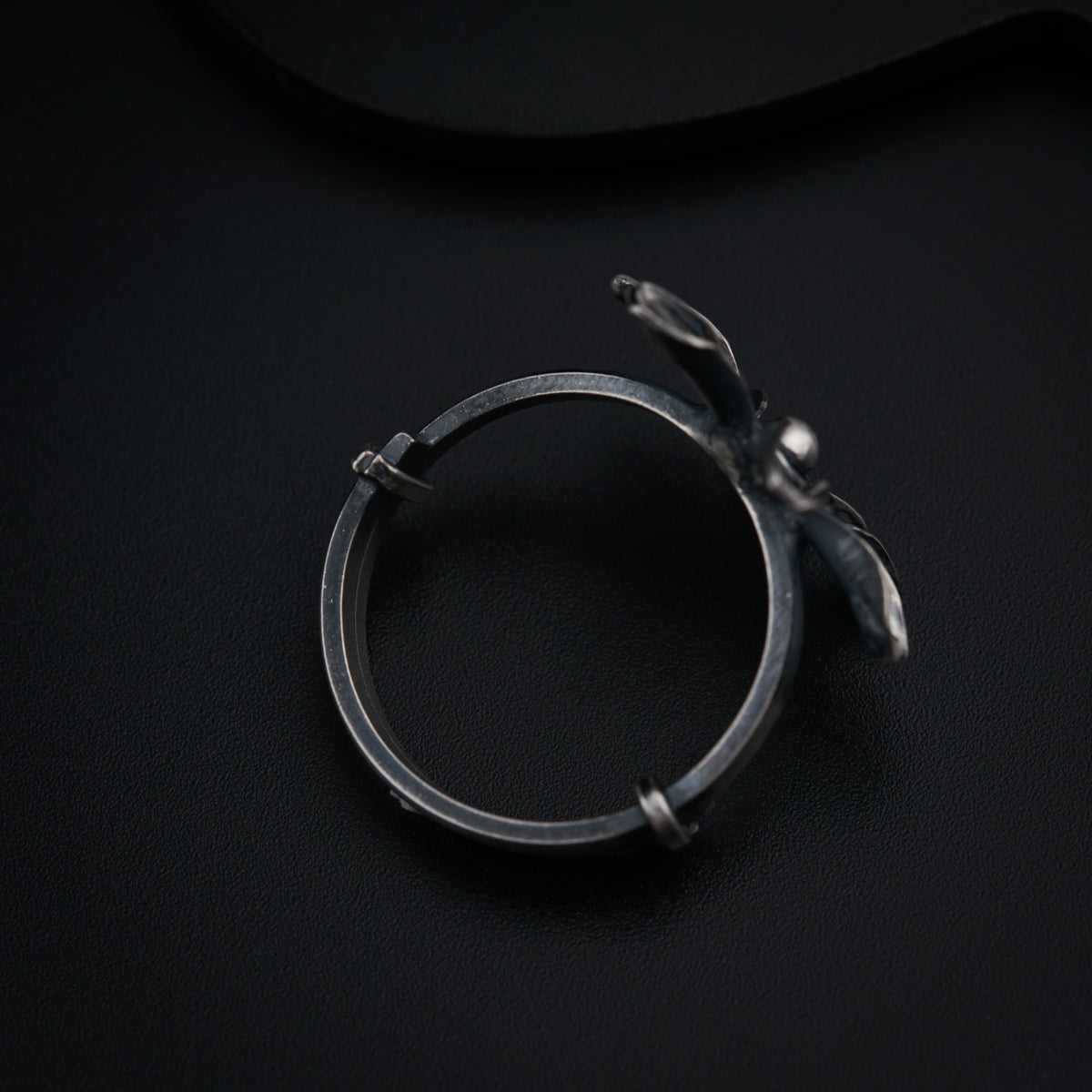 a close up of a ring on a black surface