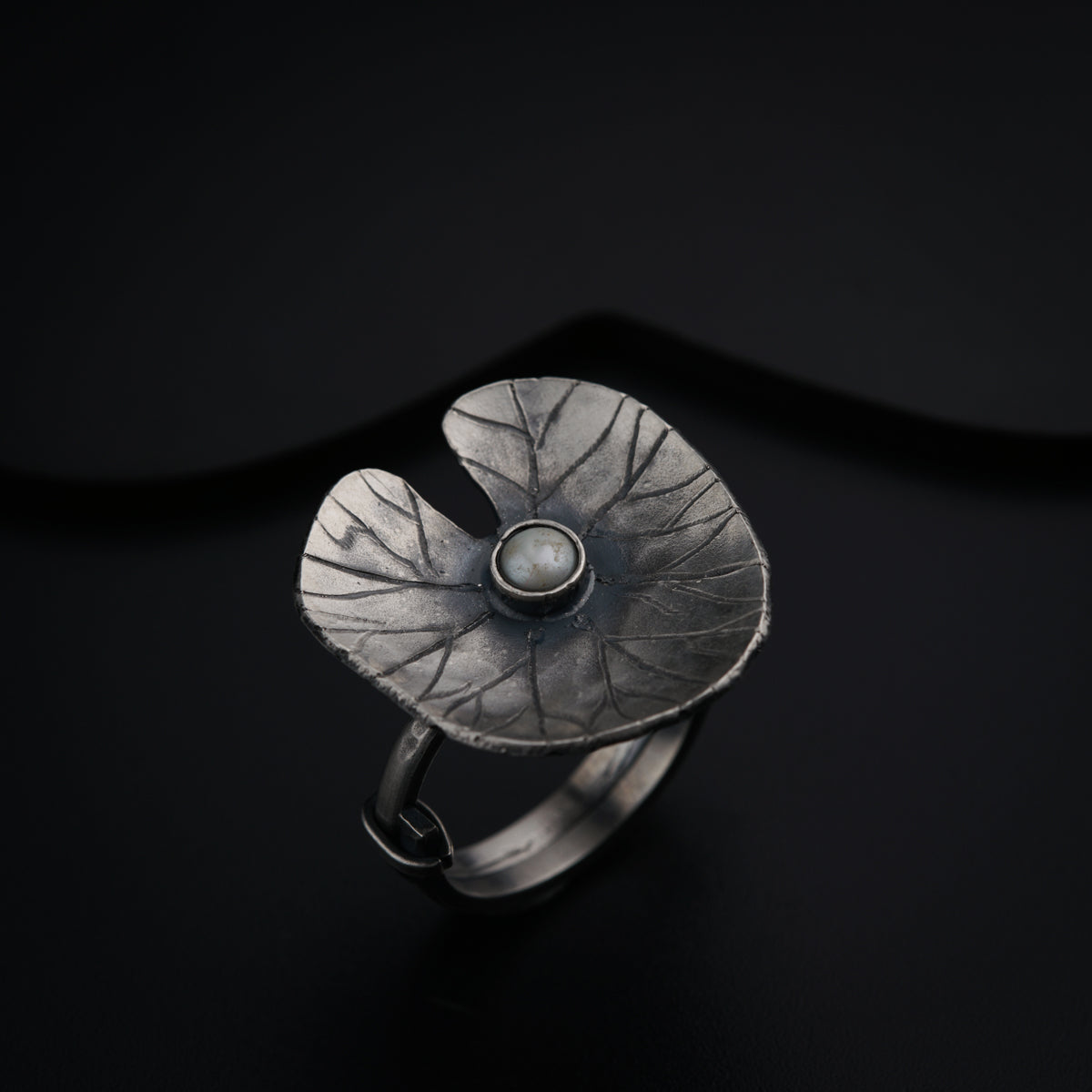 a close up of a ring on a black surface