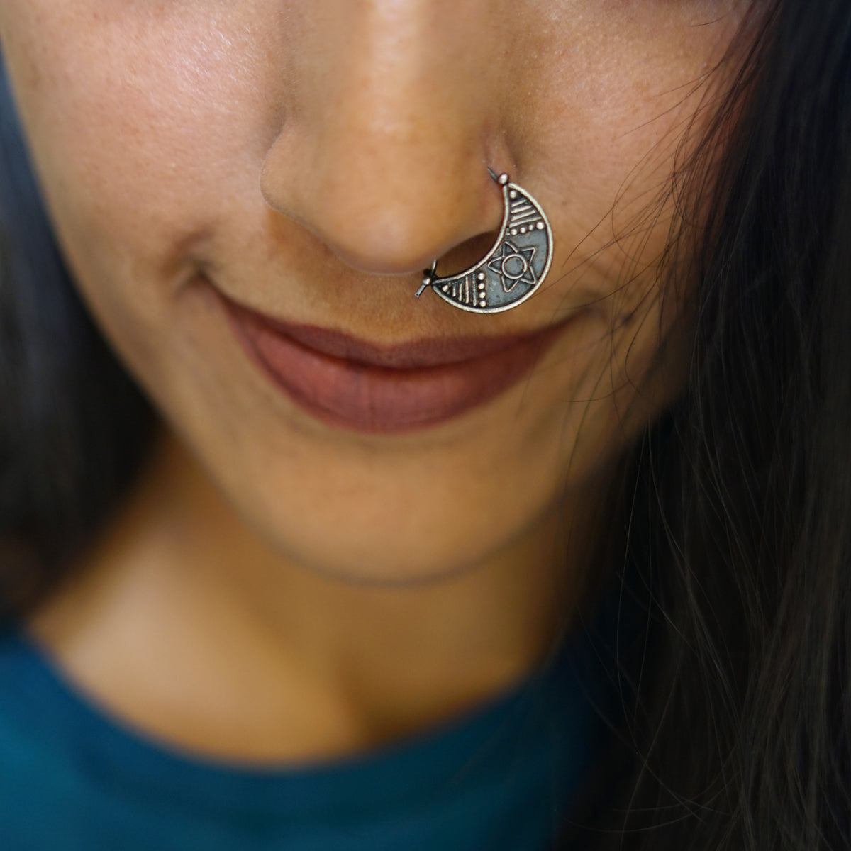 a close up of a person with a nose piercing