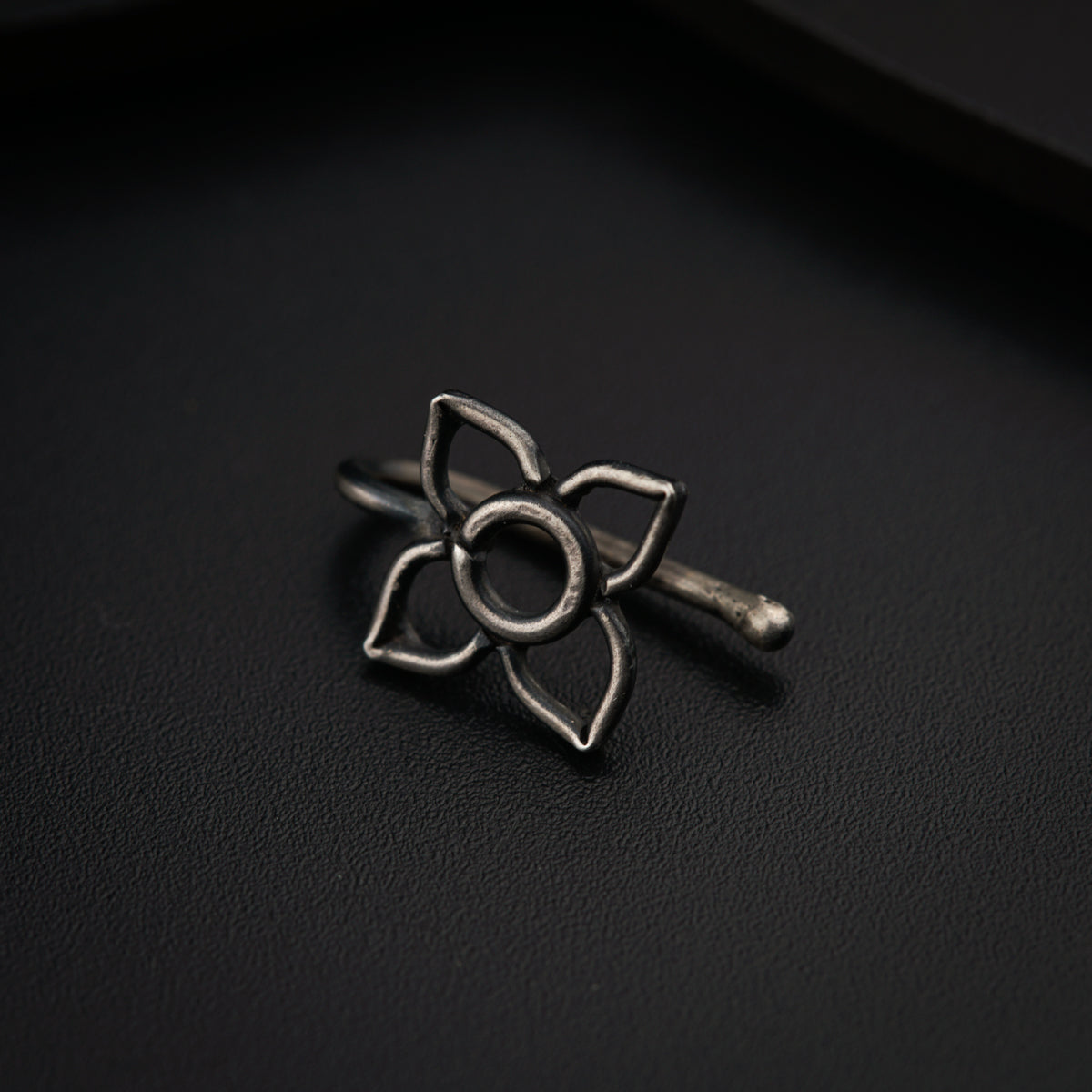 a silver ring with a flower on it