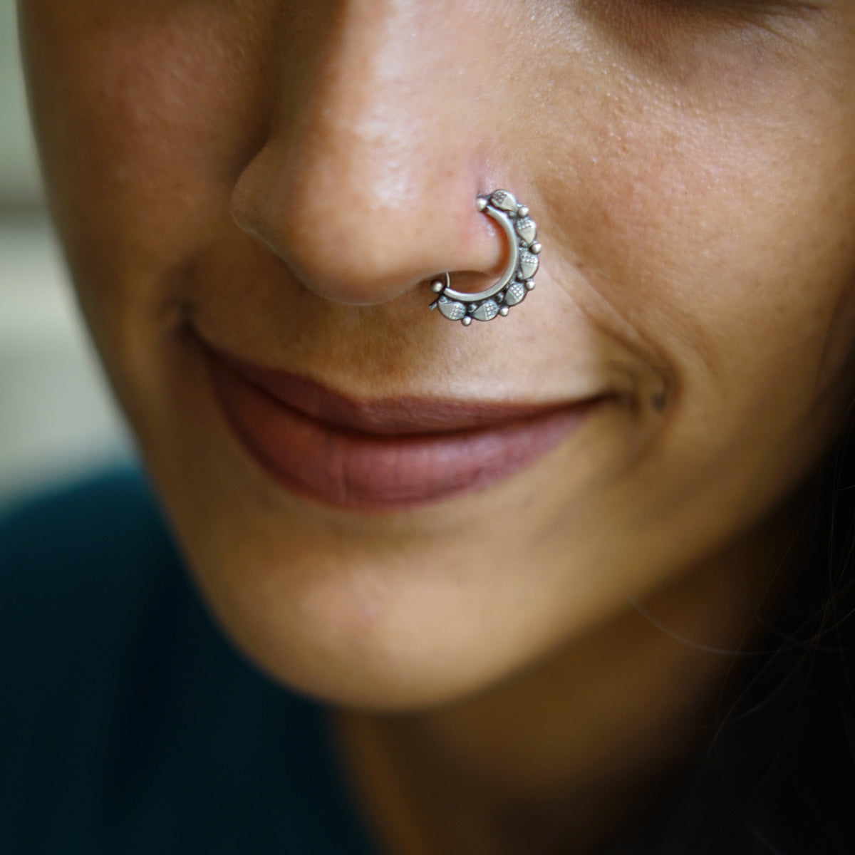 a close up of a person with a nose piercing