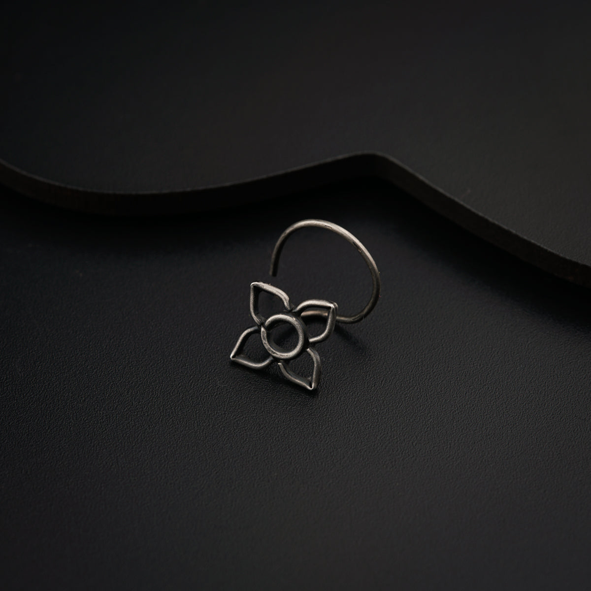 a close up of a ring on a black surface