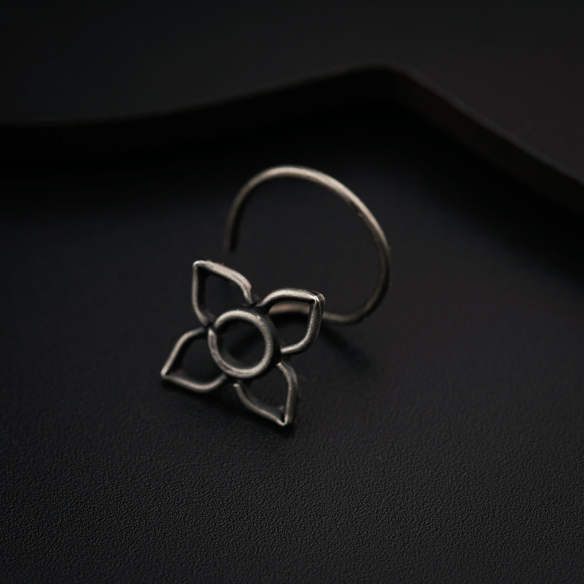 a metal ring with a flower on it