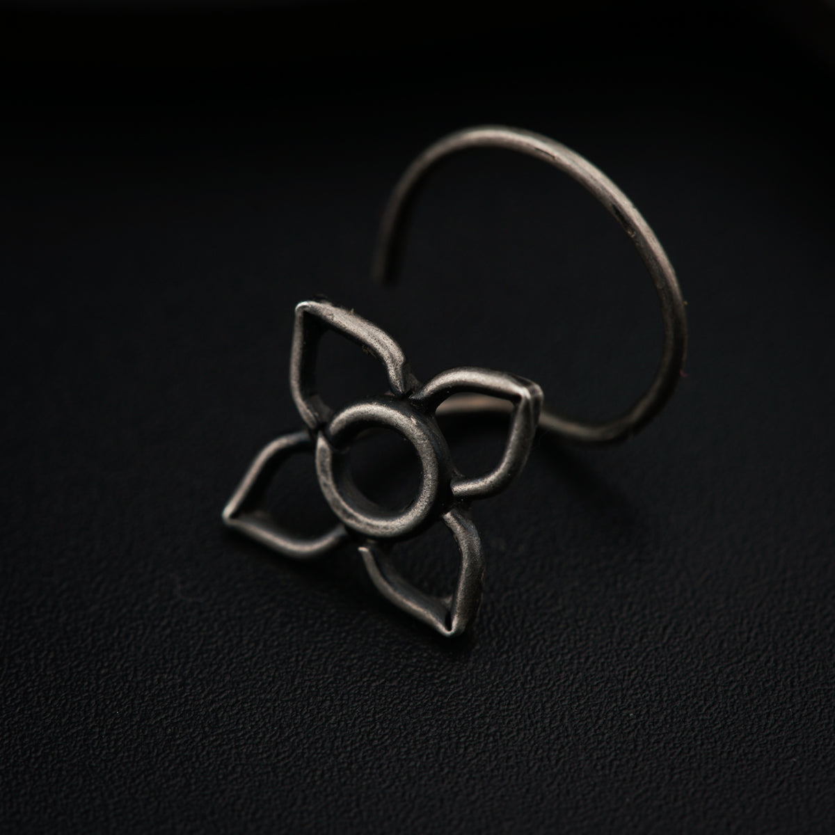 a close up of a metal object on a black surface