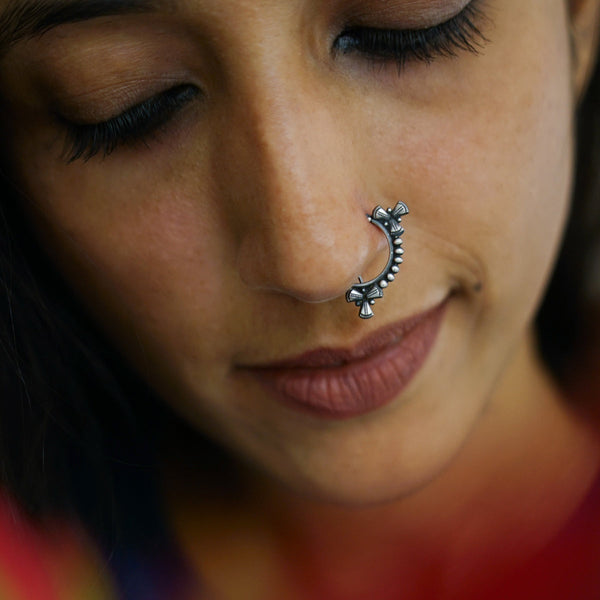 a close up of a woman with a nose piercing