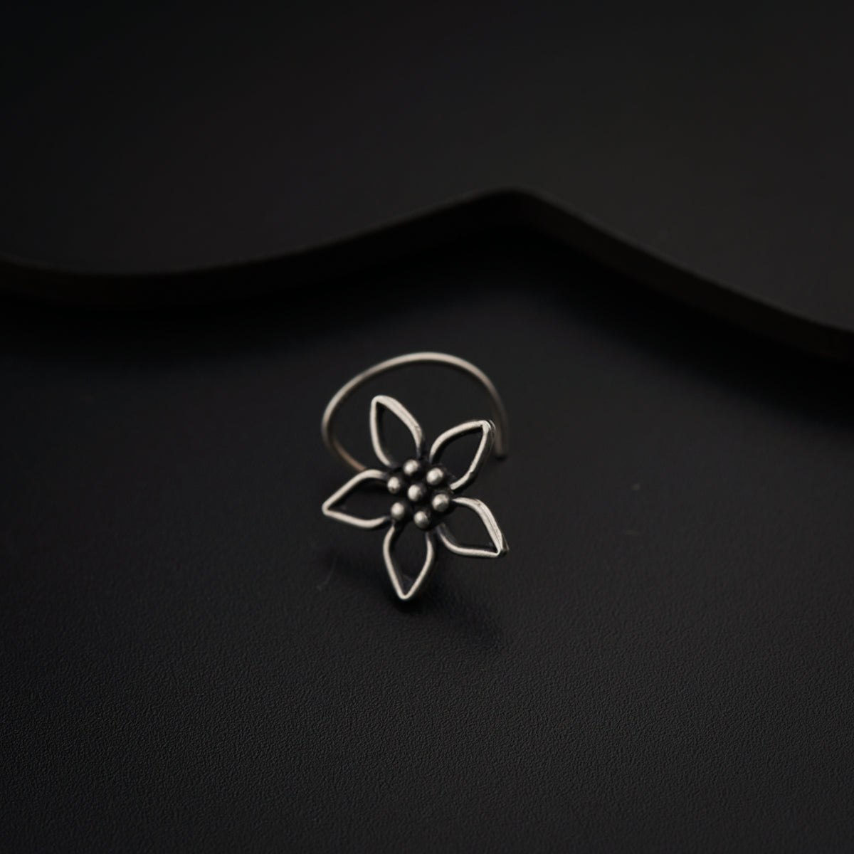 a silver ring with a flower on it