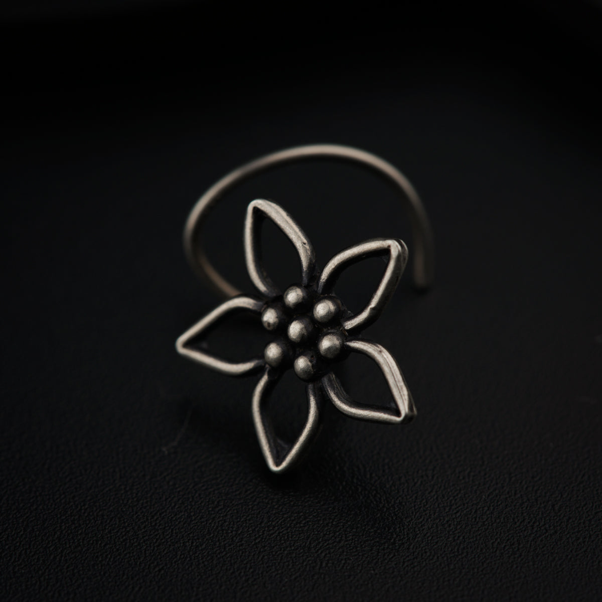 a silver ring with a flower on it