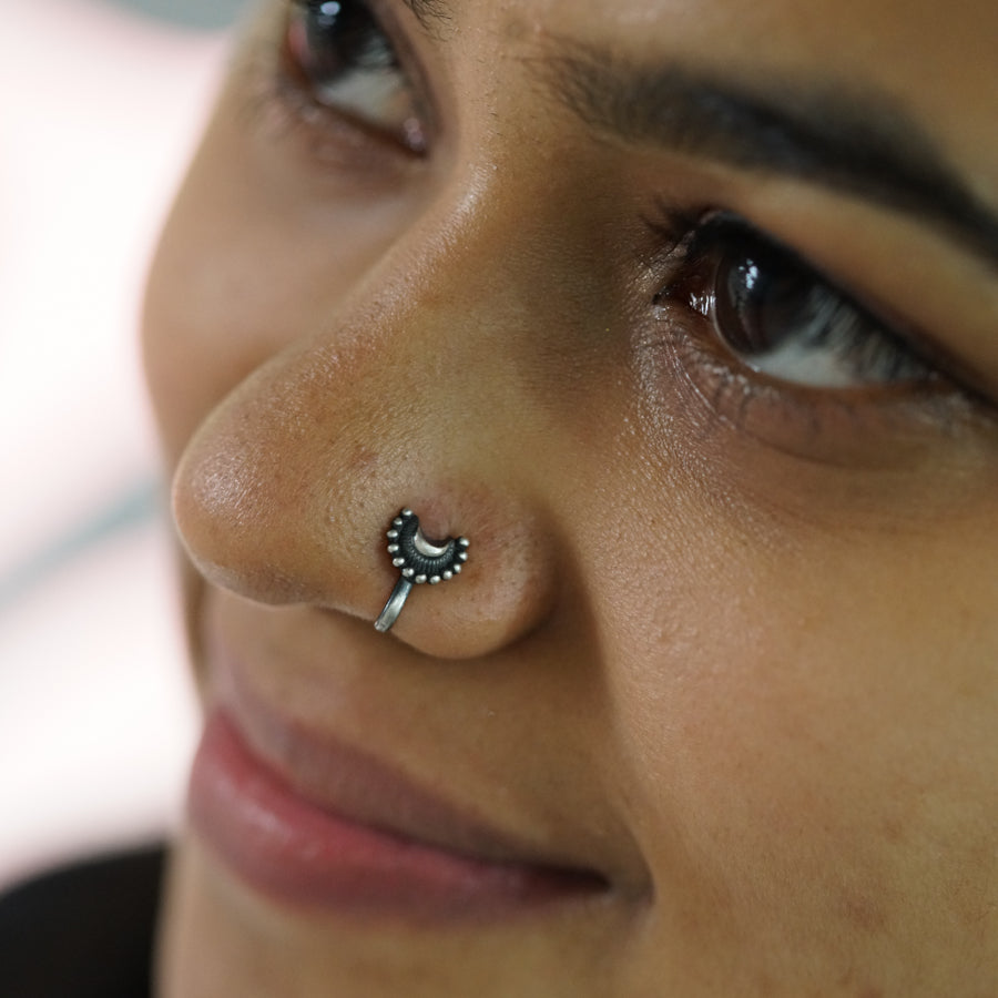 a close up of a person with a nose piercing