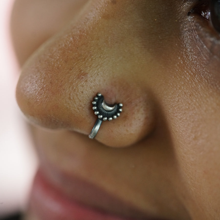 a close up of a person with a nose piercing