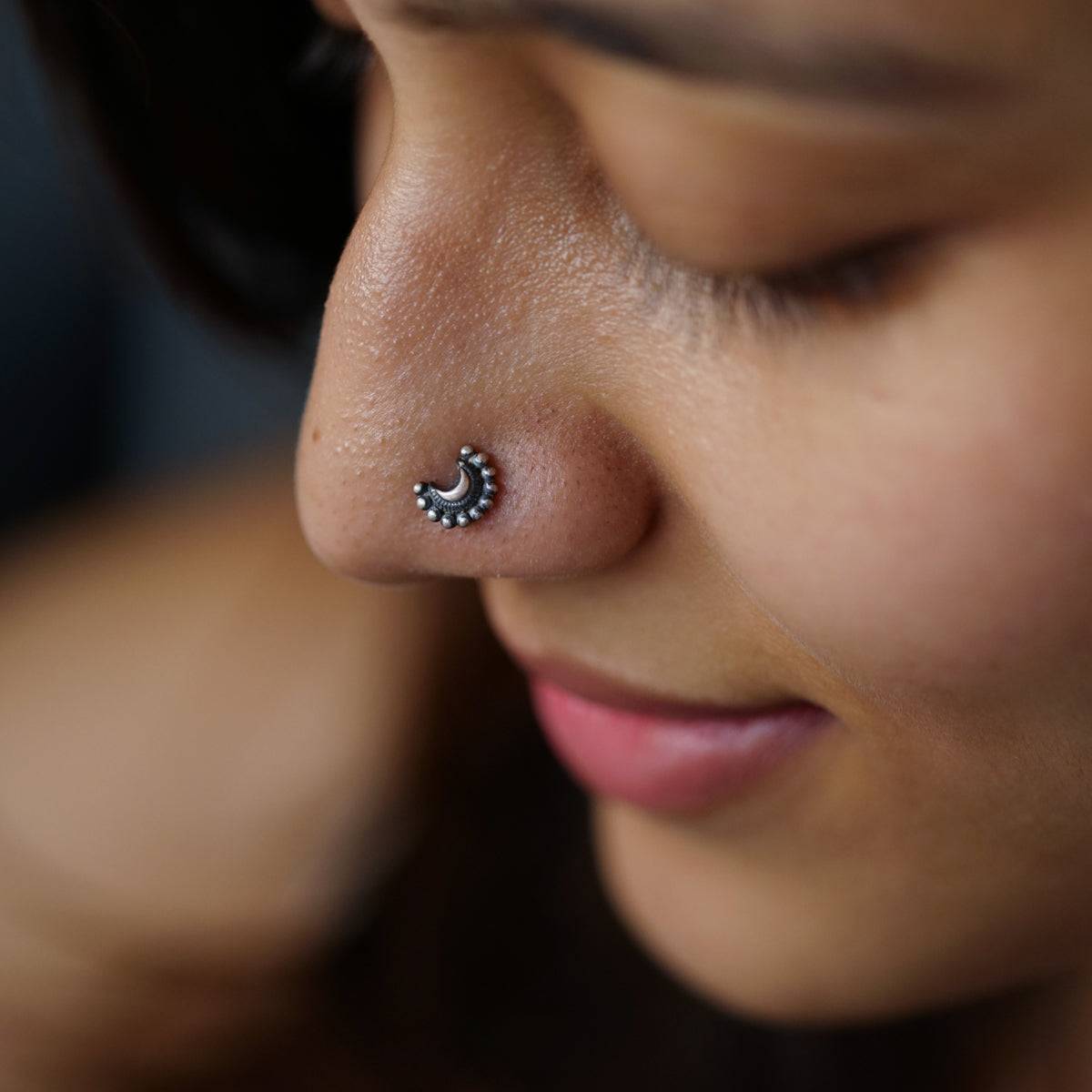 a close up of a person with a nose piercing