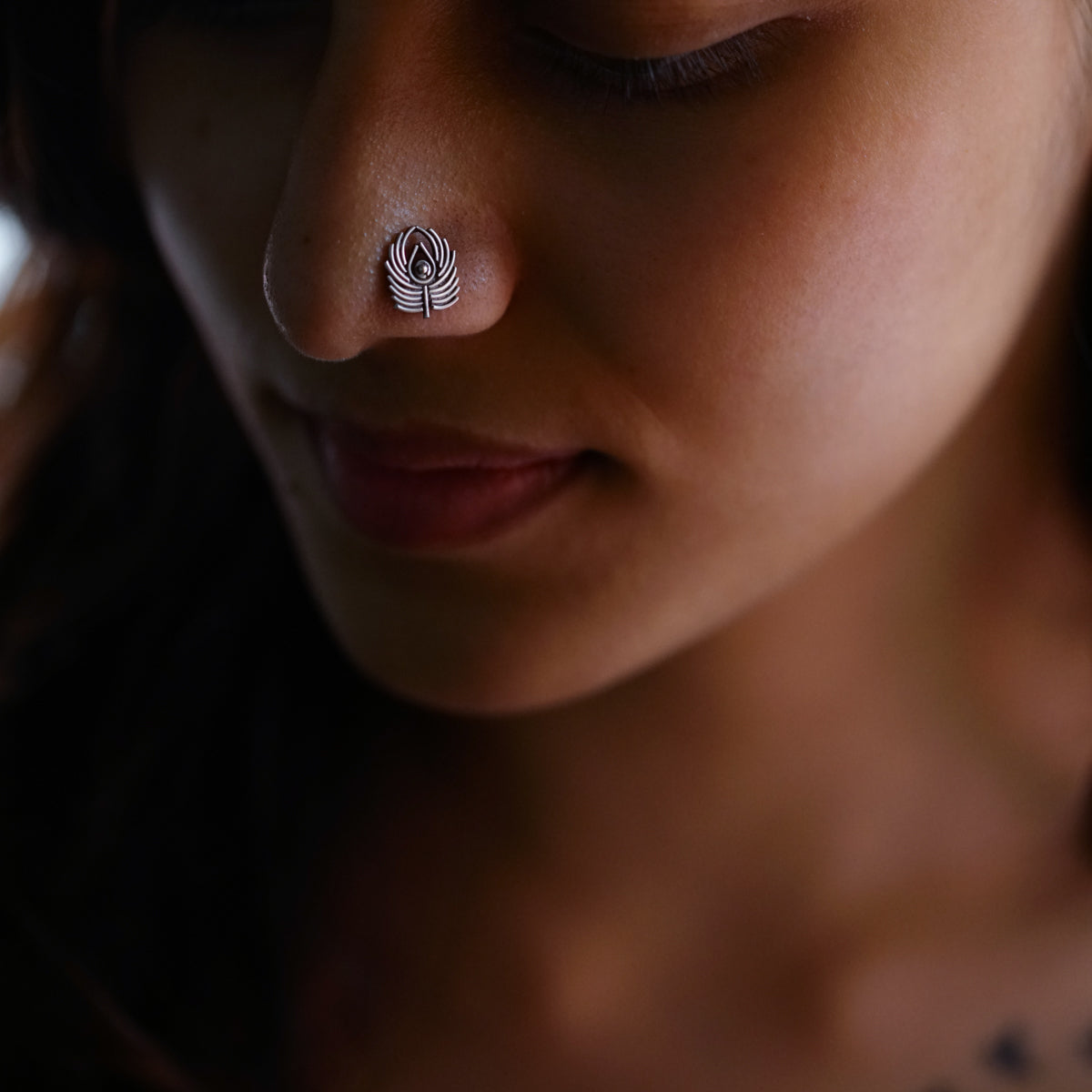 a close up of a person with a nose piercing
