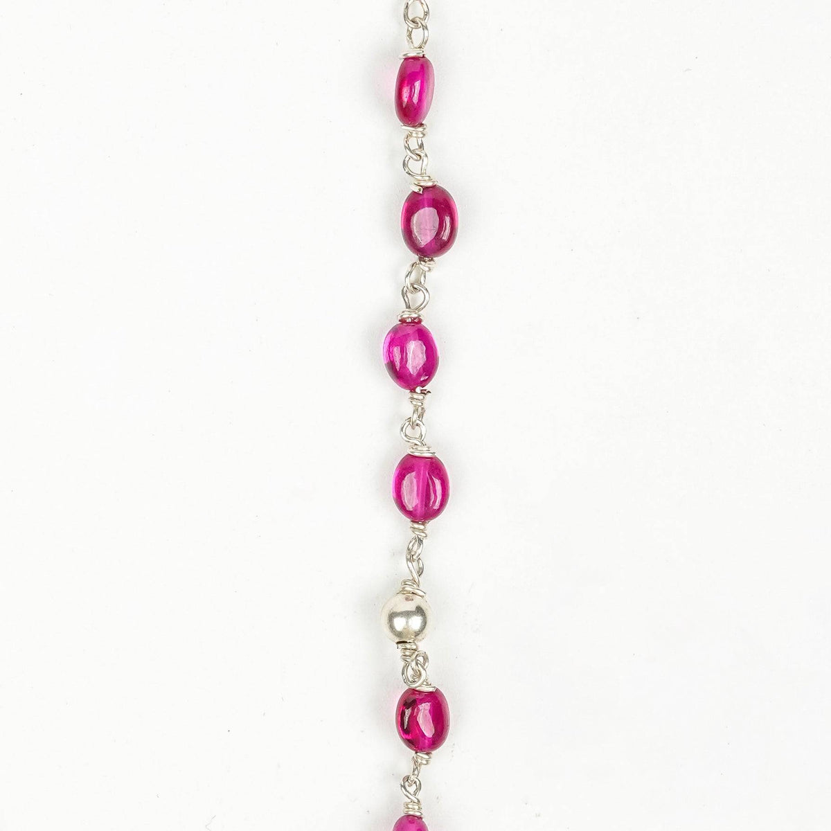 Angled view of Silver Karwar Motif Pendant & Ruby Ganthan Necklace highlighting the distinctive pendant silhouette, ruby bead arrangement, and graceful necklace structure