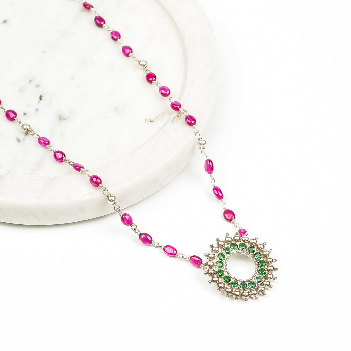 Angled view of Silver Karwar Motif Pendant & Ruby Ganthan Necklace highlighting the distinctive pendant silhouette, ruby bead arrangement, and graceful necklace structure