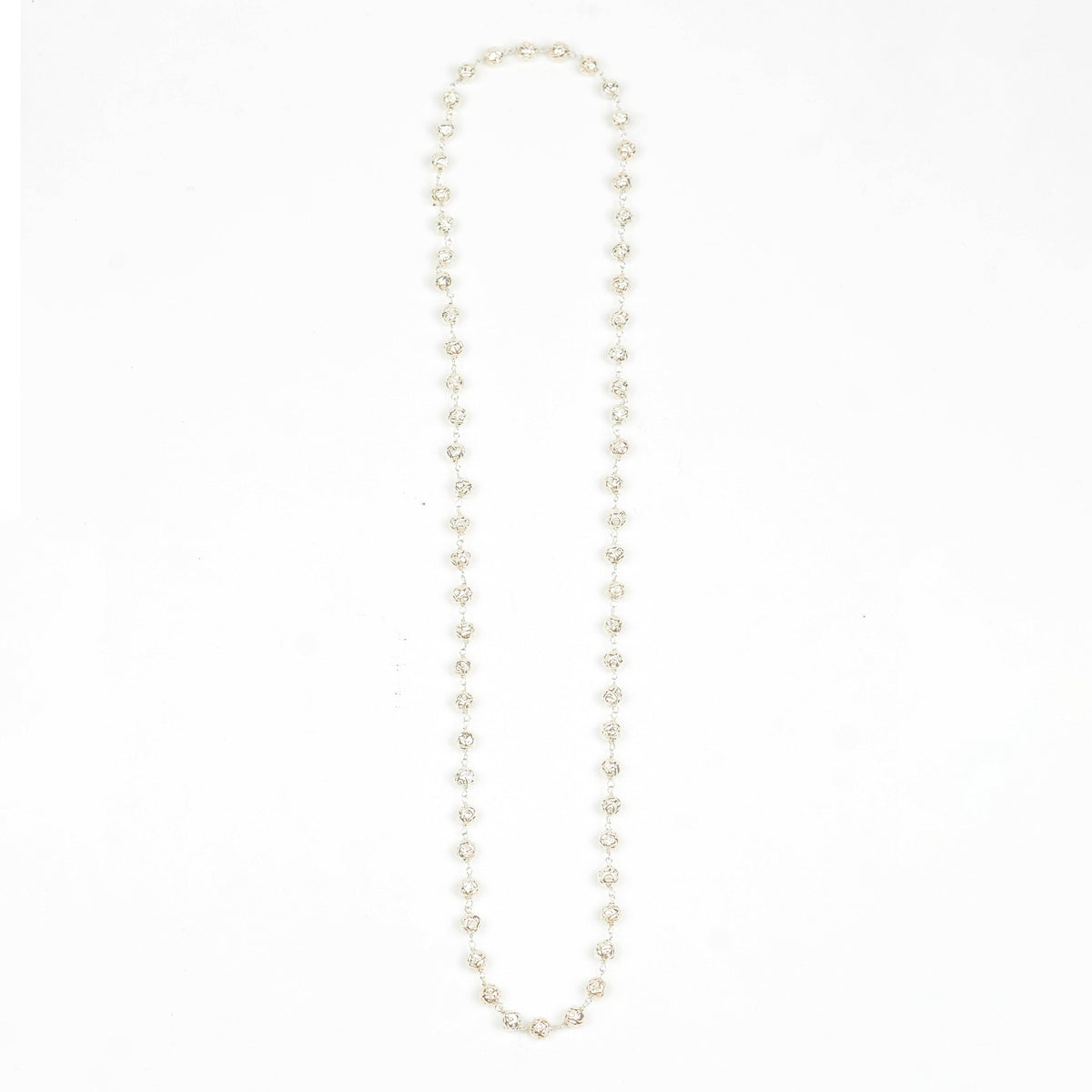 Flat-lay of a silver Mohanmaal Ganthan Necklace with complementary traditional jewellery and elegant accessories