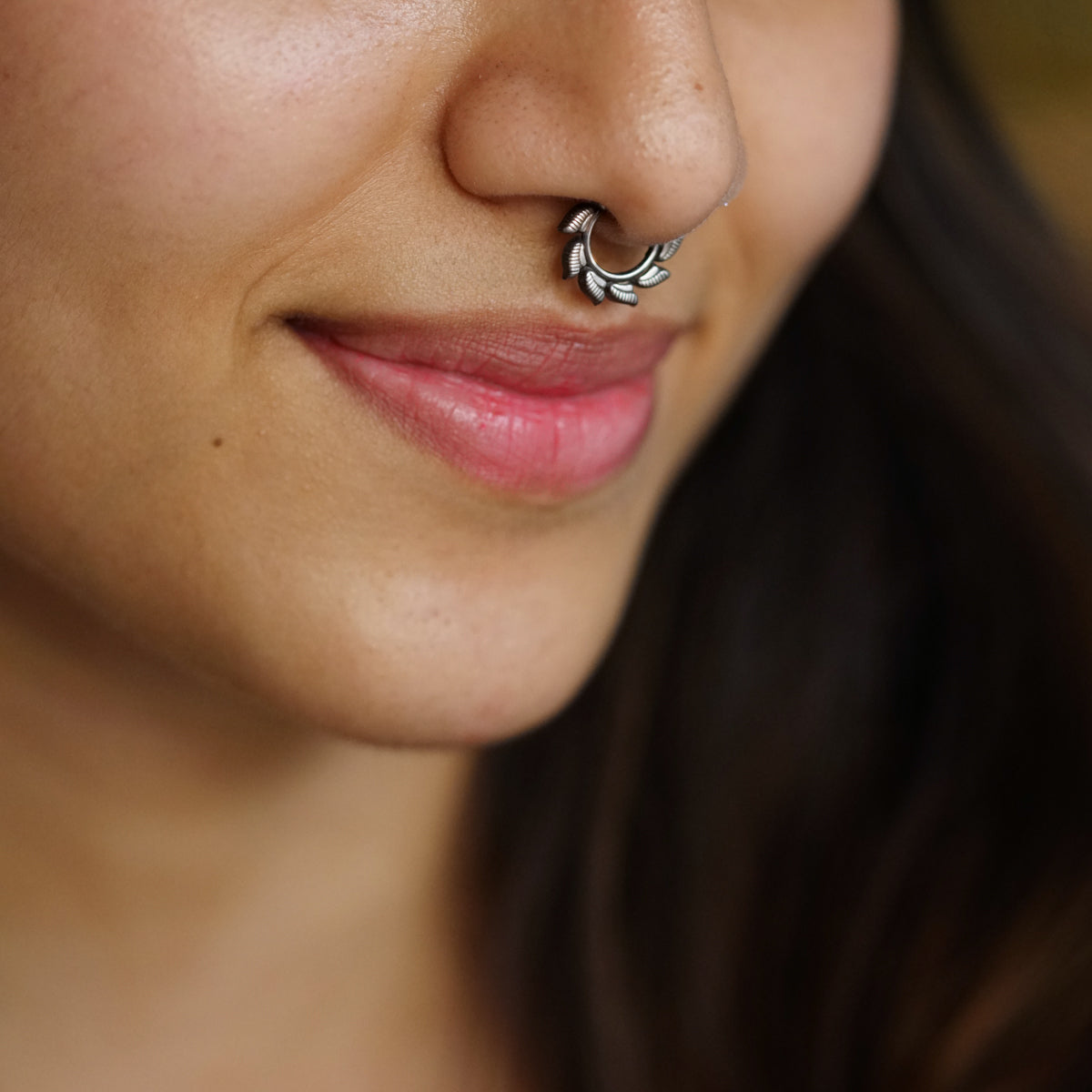 a close up of a woman with a nose piercing