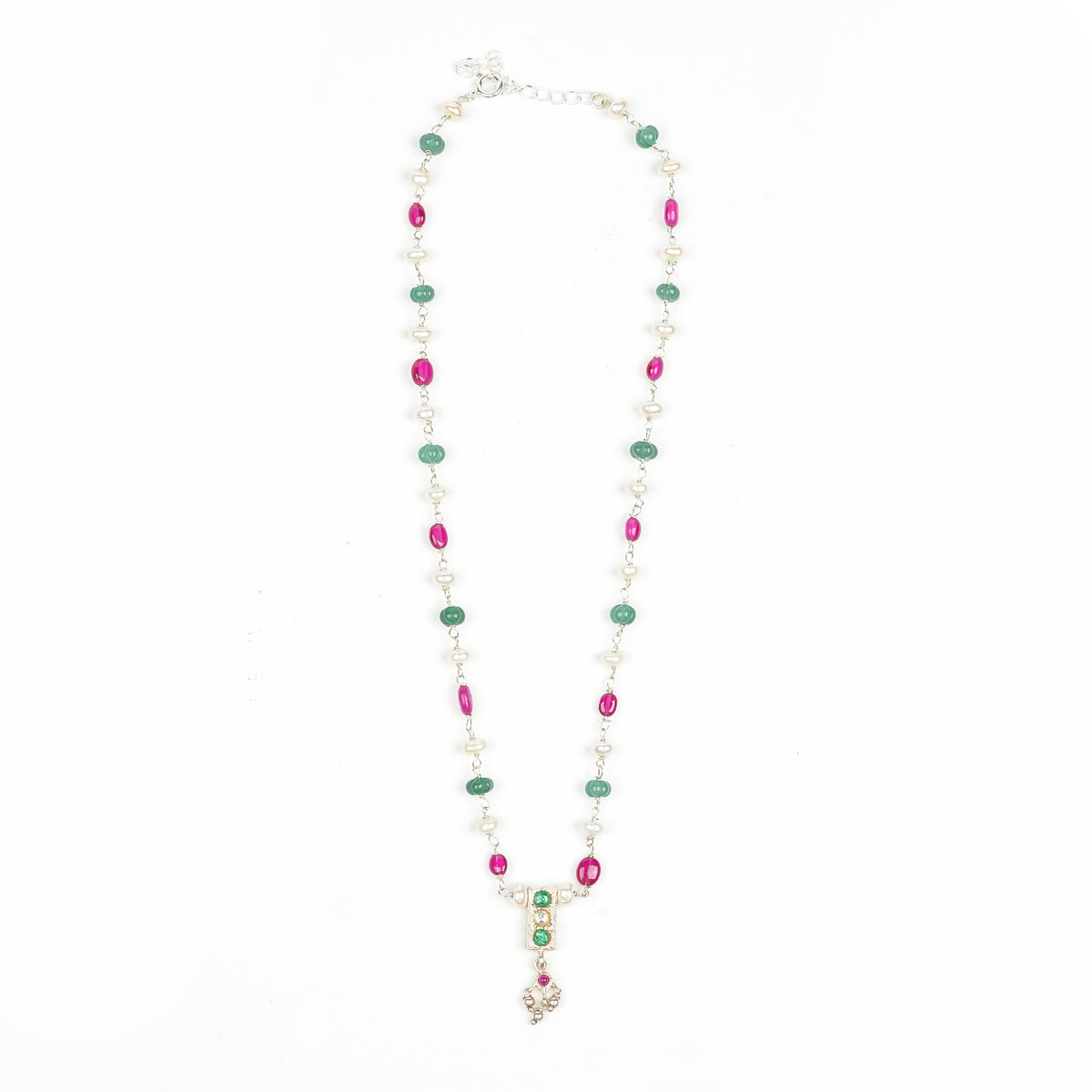 Flat-lay of a rubies, Green Onyx & Freshwater Pearl Ganthan Necklace with complementary traditional jewellery and elegant accessories
