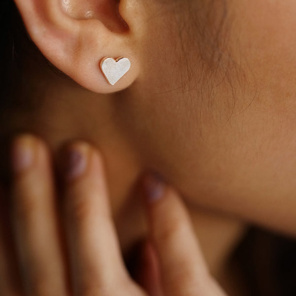 Heart shaped silver earrings detailing