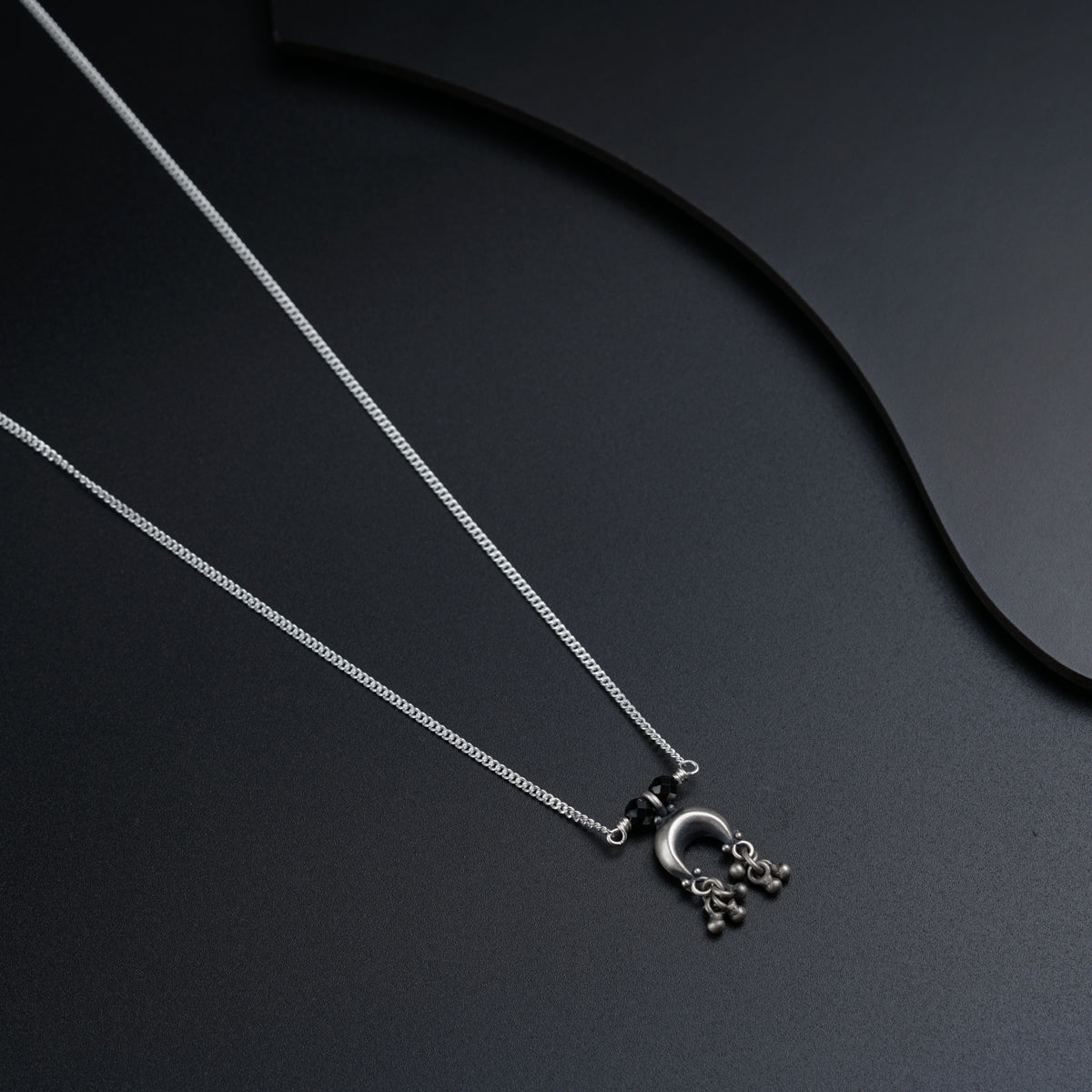 a couple of necklaces sitting on top of a table