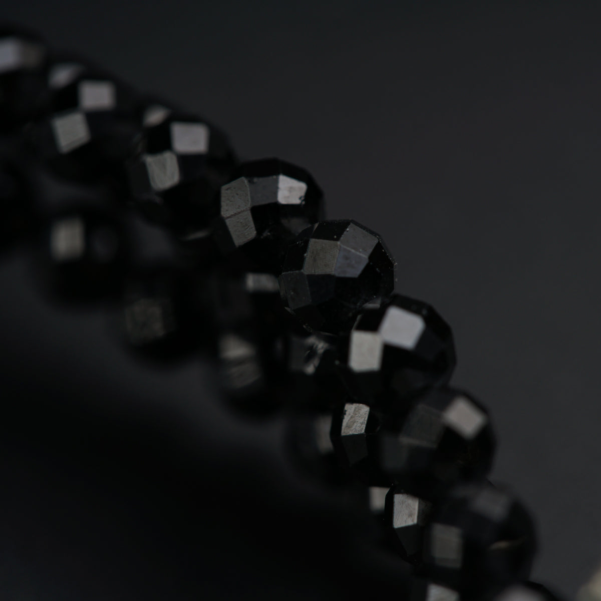 a close up of a toothbrush with black beads